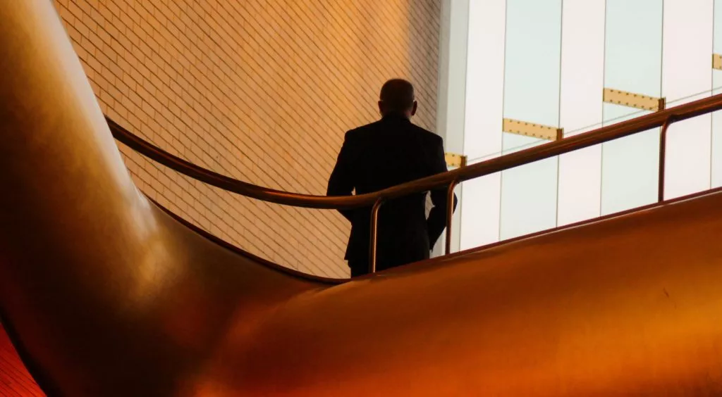 Man at top of office staircase